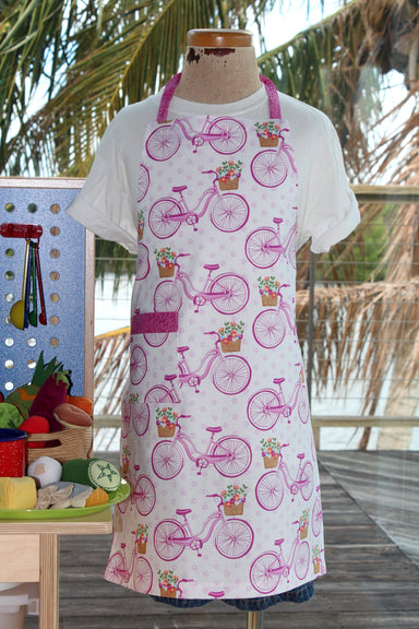 Saturday Morning Kid's Apron-The Blue Peony-Age Group_Kids,Category_Apron,Color_Pink,Department_Kitchen,Gender_Girls,Material_Cotton,Size_Medium (ages 6-11),Size_Small (ages up to 5),Theme_Spring,Theme_Transportation